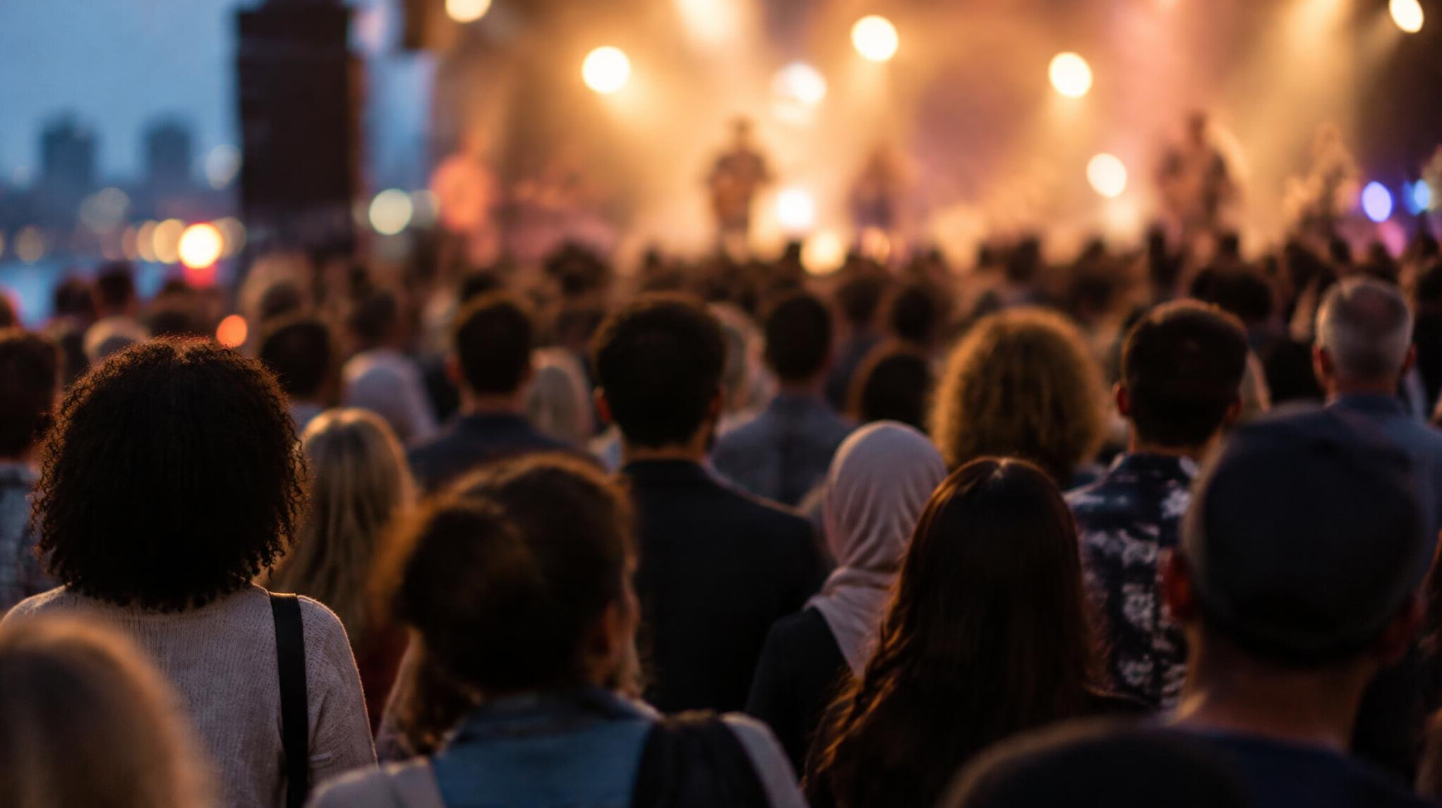 Blurred crowd at an evening event with soft stage lights